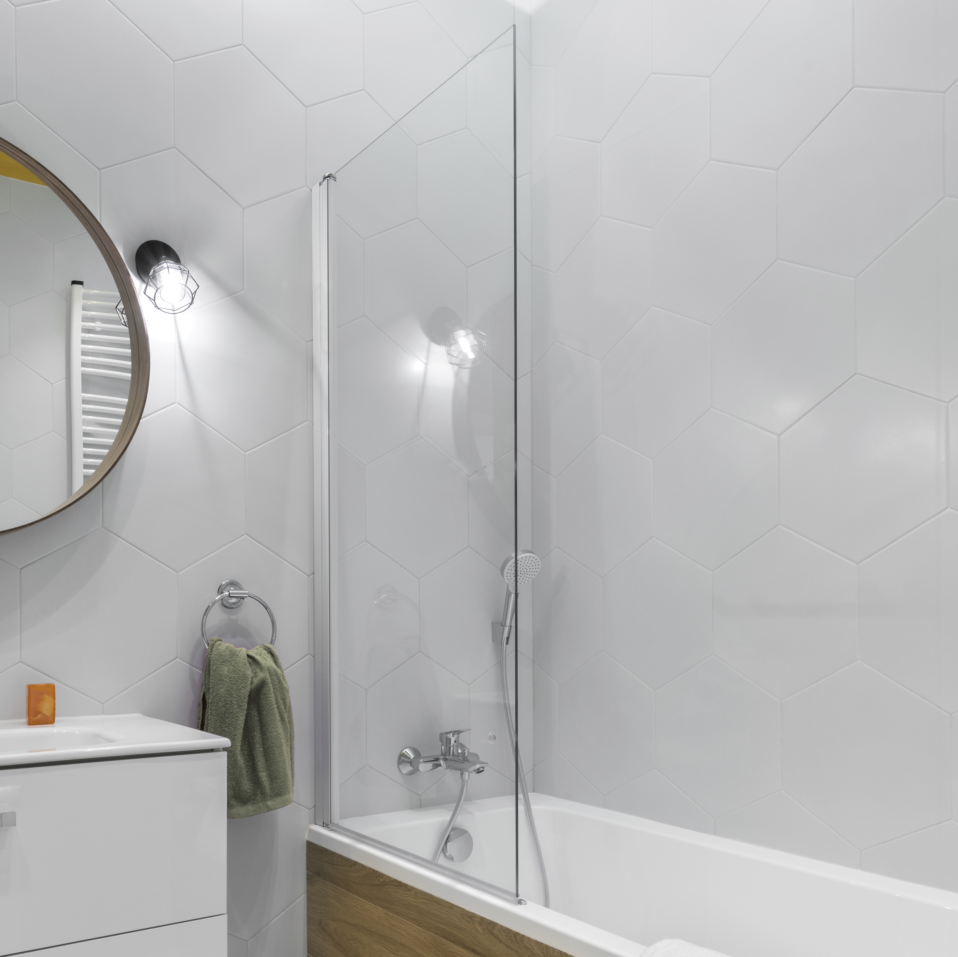 Modern bathroom with oval mirror in stylish apartment
